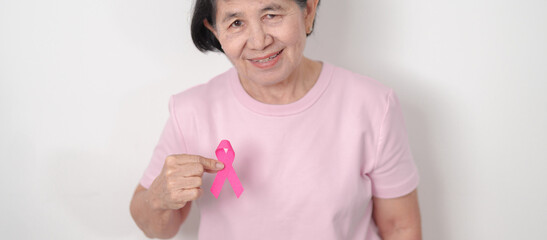 Elderly woman with pink Ribbon for Pink October Breast Cancer Awareness month, May Women Health,...