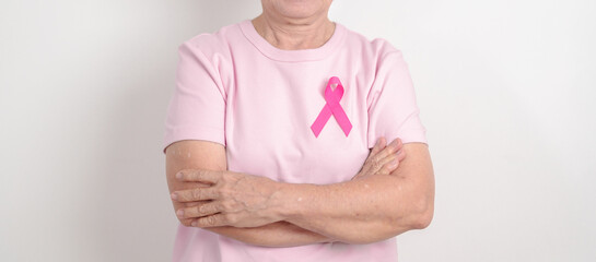 Elderly woman with pink Ribbon for Pink October Breast Cancer Awareness month, May Women Health,...