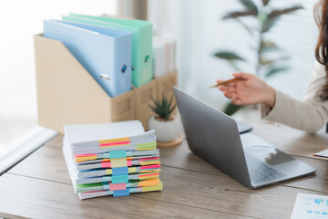 Organization and Productivity: The image showcases a close-up of a workspace featuring a laptop,...