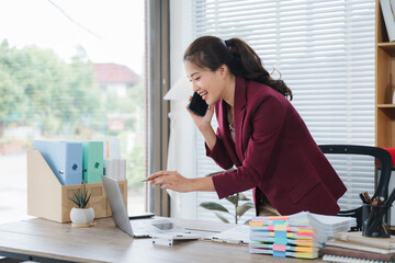 Confident Communicator at Work: A poised professional woman in smart attire is engaged in a dynamic...