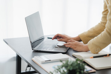 Focused Work: A person diligently working at a sleek, modern workstation. Hands poised over a...