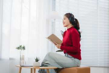Harmony in Recording: A woman sits in a sun-drenched room, engrossed in recording, microphone in...