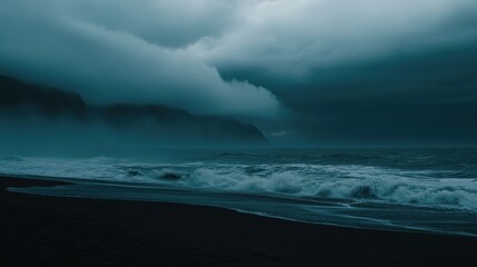 Naklejka premium Black sand beach, dark clouds, and foggy mountains in the background. Icelandic landscape, 