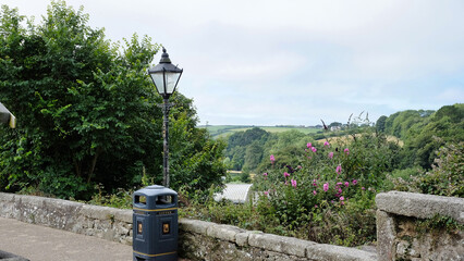 view of Helston boating lake past a street light and a bin