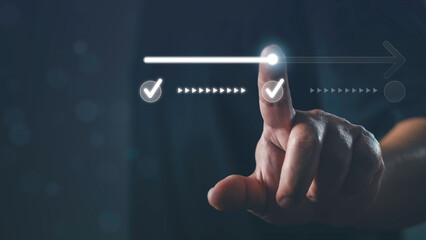 Hand pointing at digital checklist with progress bar and check marks, representing task completion,...