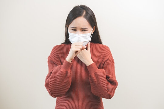 Unhealthy sickness, unwell asian young woman wearing mask coughing, have sore throat, suffering symptom cough feeling bad and healthcare of air pollution and dust, PM2.5 isolated white background. - Powered by Adobe