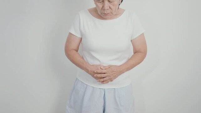 Elderly woman having Colon pain for Colonic disease, Inflammatory Bowel, IBD, Colorectal cancer, Ulcerative colitis, Diverticulitis, Irritable bowel syndrome, Digestive system and Health concept
