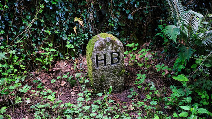 granite post with the letters HB 