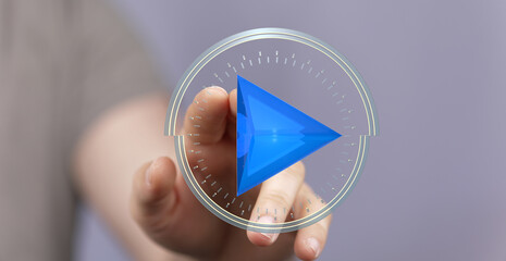 Person interacts with a digital play button interface. Modern technology concept.