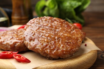 Delicious hamburger patties and spices on table, closeup