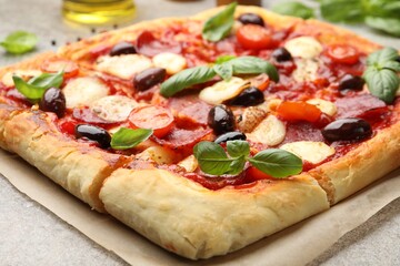 Tasty square homemade pizza on grey table, closeup