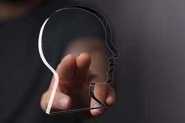 Abstract image of a hand interacting with a transparent head, symbolizing concepts like mind,...