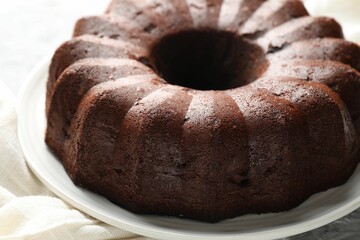 Tasty chocolate bundt cake on table, closeup