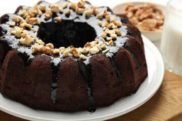 Delicious chocolate bundt cake with nuts on table, closeup