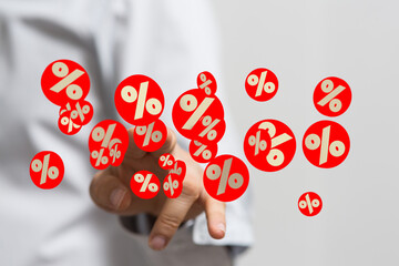 Image of a person's hand interacting with floating percentage symbols, ideal for finance, sales,...