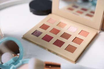 Different makeup products on white table, closeup