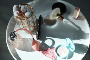 Different makeup products on white table indoors, above view