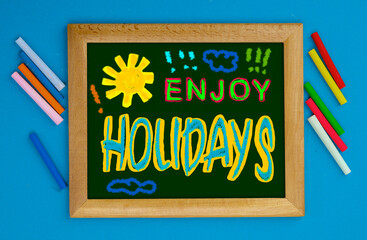 School Holidays concept. Fun colorful inscriptions in a children's style on chalkboard. School...