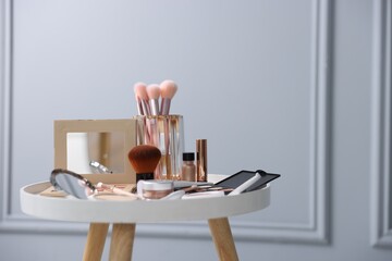 Different makeup products on white table indoors, space for text