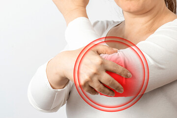 Arthritis symptoms, suffering from pain. The hands of the woman massage a painful elbow. Inflamed male joint, stiffness of movement. Close up view