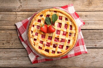 Tasty strawberry pie on wooden table, top view