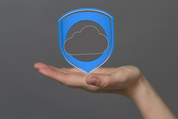 Image of a hand holding a digital shield protecting cloud data, symbolizing secure cloud storage...
