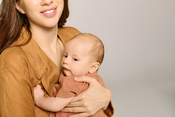 Beautiful young mother embraces her little child in a warm and loving moment