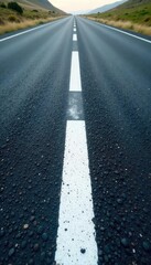 Crisp White Line on Dark Asphalt Road Stretching to Horizon - Graphic Element for Journey, Direction, Simplicity Concepts