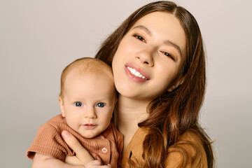 Young mother shares a joyful moment with her adorable baby in a warm embrace at home
