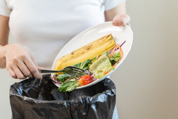 Compost from leftover food in the meal in household, female hand holding left over meal use fork...