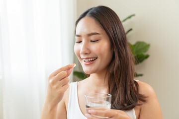 person prepare fish oil pills to her hands taking daily supplement
