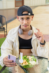 Non binary gay man eating salad