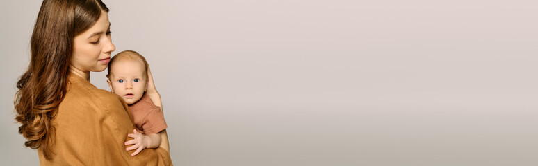 Beautiful young mother lovingly holds her little child in a serene moment of parenthood