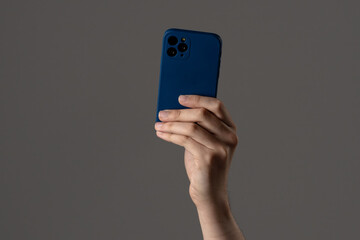 Modern Smartphone Held in Hand Against Neutral Background