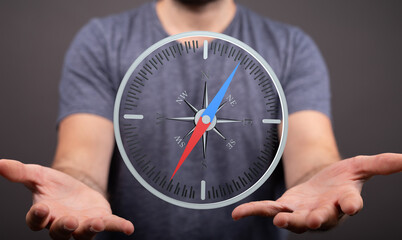 A man holds a compass, symbolizing guidance, direction, and finding your way.