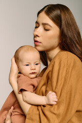 Mother embraces her infant child in a tender moment of connection and love