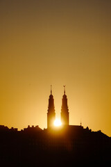 Fototapeta premium Low angle view of towers against sky during sunset