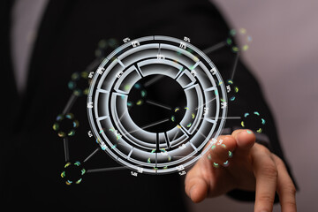 Stock photo of a businessman interacting with a holographic data visualization.