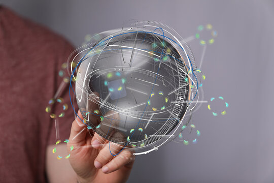 Abstract image of a person holding a digital globe, representing global connectivity and data flow. - Powered by Adobe