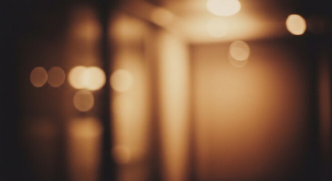 Abstract blurred image of a room interior with warm lighting creating bokeh effects.