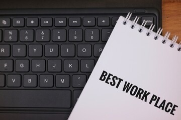 Notebook With 'Best Workplace' on Keyboard Signifying Professional Excellence