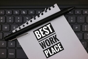 Notebook With 'Best Workplace' on Keyboard Signifying Professional Excellence