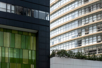 Glass and metal facades merge in shifting reflections, composing abstract urban surfaces full of geometric tension, vibrant color changes and crisp architectural lines under brilliant daylight skies.