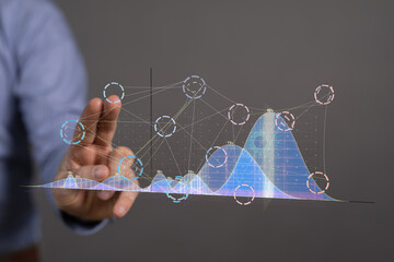 Businessman interacts with holographic charts and graphs.  Data analysis, technology concept.