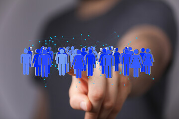 Image of a hand interacting with a digital network of people, symbolizing global connection and...