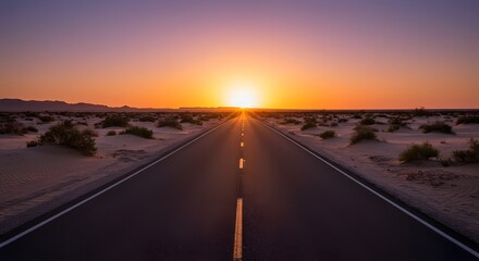 Naklejka premium Desert road stretching to the horizon at sunset, clear sky above, plants on either side of the road.