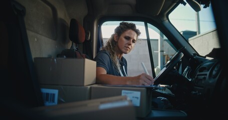 Female Product Supplier in Truck Talking by Phone, Using Digital Tablet, Filling Out Papers. Woman Working in Express Delivery Service, Delivering Cardboard Boxes with Online Orders, E-Commerce Goods.