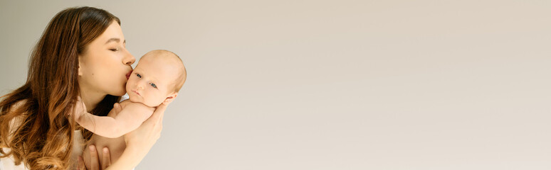 Embracing the joy of motherhood, a young mother shares a tender moment with her baby