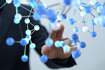 Abstract image of a businessman interacting with a digital network, representing connection and...