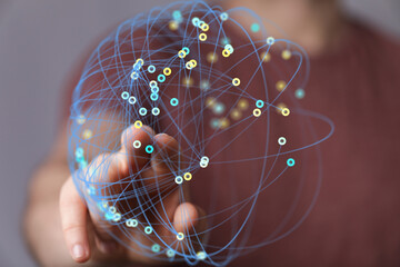 Hand interacting with a digital network, representing global connections and data flow.